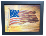 Framed artwork of an American flag against a sunset sky