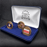 Three gold coins in a blue display case with a black background